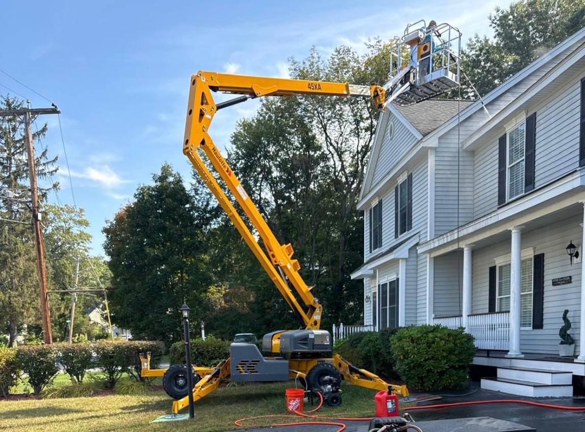 Articulated lift positioned beside a house